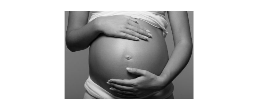 Image of a pregnant person's round belly with two hands supporting it, like the positive support we hope pregnant people over 35 receive