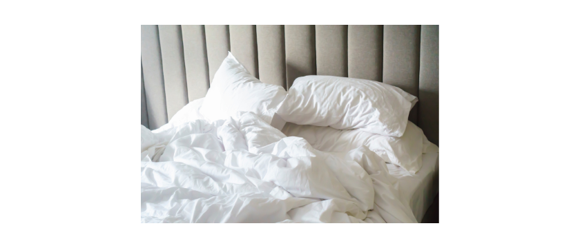 A bed with rumpled sheets and a headboard for banging - clearly not a house with tired parents and a toddler